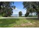 Scenic view of a lake with lush greenery and a road at 1689 Lakeshore Dr, Eustis, FL 32726