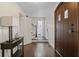 Bright entryway with dark hardwood floors, a table, and staircase at 1689 Lakeshore Dr, Eustis, FL 32726