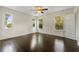 Bright bedroom with hardwood floors and multiple windows at 1689 Lakeshore Dr, Eustis, FL 32726