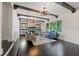 Spacious living room with fireplace, built-in shelving and hardwood floors at 1689 Lakeshore Dr, Eustis, FL 32726
