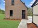Brick garage with a walkway and landscaping at 1689 Lakeshore Dr, Eustis, FL 32726