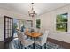Bright dining room features a chandelier and access to a back porch with lake views at 1689 Lakeshore Dr, Eustis, FL 32726