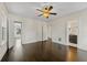 Spacious bedroom with hardwood floors, ceiling fan, and multiple windows at 1689 Lakeshore Dr, Eustis, FL 32726