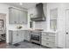 Modern kitchen with stainless steel appliances and a statement hood at 1689 Lakeshore Dr, Eustis, FL 32726