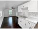 Charming kitchen with white cabinets and marble countertops at 1689 Lakeshore Dr, Eustis, FL 32726