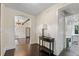 Hallway with dark hardwood floors, a table, and access to kitchen at 1689 Lakeshore Dr, Eustis, FL 32726