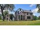 Brick home with a sunroom and detached garage at 1689 Lakeshore Dr, Eustis, FL 32726