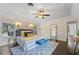 Main bedroom with hardwood floors, and a ceiling fan at 1689 Lakeshore Dr, Eustis, FL 32726