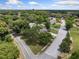 Two-story house nestled among lush trees near a lake at 1689 Lakeshore Dr, Eustis, FL 32726