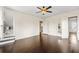 Spacious bedroom with hardwood floors, ceiling fan, and access to other rooms at 1689 Lakeshore Dr, Eustis, FL 32726