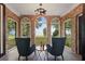 Sunroom with brick walls, lake view, and comfortable seating at 1689 Lakeshore Dr, Eustis, FL 32726