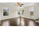 Bright bedroom featuring hardwood floors and multiple windows at 1689 Lakeshore Dr, Eustis, FL 32726