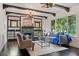 Living room with fireplace, hardwood floors, and ample natural light at 1689 Lakeshore Dr, Eustis, FL 32726