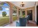 Sunroom with brick walls, lake view, and comfortable seating at 1689 Lakeshore Dr, Eustis, FL 32726