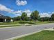 Community view showing homes, landscaping, and pond at 3462 Barina St, Saint Cloud, FL 34769