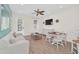 Bright living room with light beige couch and white dining set at 8016 Flip Flop Way, Kissimmee, FL 34747