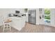 Modern kitchen with white cabinets, stainless steel appliances, and breakfast bar at 8016 Flip Flop Way, Kissimmee, FL 34747
