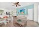 Living area features a sofa, dining table, and access to the outdoors at 8016 Flip Flop Way, Kissimmee, FL 34747