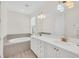 Bathroom boasts double vanity, soaking tub, and modern fixtures at 8016 Flip Flop Way, Kissimmee, FL 34747
