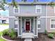 Gray two-story house with a red front door and covered porch at 6364 Lake Smith Cir, Windermere, FL 34786