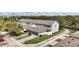 Aerial view of townhouses with attached garages, and a lake in the background at 6364 Lake Smith Cir, Windermere, FL 34786