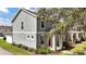 Gray townhome with red door and landscaping at 6364 Lake Smith Cir, Windermere, FL 34786
