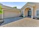 One-story house with a two-car garage and brick paver driveway at 125 Dolcetto Dr, Davenport, FL 33897