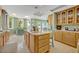 Well-equipped kitchen boasts ample cabinetry and an island at 9 Stone Gate N, Longwood, FL 32779