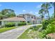 Two-story house with a circular driveway and lush landscaping at 9 Stone Gate N, Longwood, FL 32779