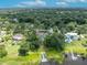 Aerial view of waterfront property with lush landscaping and private dock at 9 Stone Gate N, Longwood, FL 32779