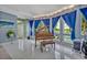 Grand piano in living room with large windows showcasing a pool and backyard view at 9 Stone Gate N, Longwood, FL 32779