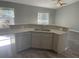 Kitchen island with granite countertop and stainless steel dishwasher at 142 Fisher Run, Ocklawaha, FL 32179