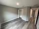 Spacious bedroom with wood-look flooring and a double-door closet at 39 Fisher Lane Trak, Ocklawaha, FL 32179