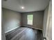Simple bedroom with wood-look flooring and a window at 39 Fisher Lane Trak, Ocklawaha, FL 32179