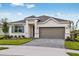 One-story home with gray roof, light-colored walls, and a paved driveway at 2014 Firethorn Loop, Haines City, FL 33844