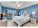 Blue bedroom with king-size bed and balcony access at 3801 S Atlantic Ave # 321, New Smyrna Beach, FL 32169