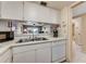 Kitchen with double sink, dishwasher, and view to living room at 3801 S Atlantic Ave # 321, New Smyrna Beach, FL 32169