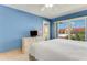 Blue bedroom with king-size bed and large window at 3801 S Atlantic Ave # 321, New Smyrna Beach, FL 32169