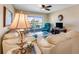 Living room with beige sofa and view to balcony at 3801 S Atlantic Ave # 321, New Smyrna Beach, FL 32169