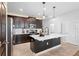 Eat-in kitchen with island, dark cabinetry, and white countertops at 11109 Folklore St, Winter Garden, FL 34787