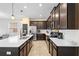 Modern kitchen with dark cabinetry, white countertops, and a large island at 11109 Folklore St, Winter Garden, FL 34787