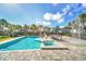 Inviting pool and spa with a waterslide and lounge chairs at 7706 Graben St, Kissimmee, FL 34747