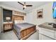 Guest bedroom with a wooden bed frame and neutral color scheme at 7706 Graben St, Kissimmee, FL 34747