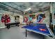 Game room with air hockey, foosball, ping pong, and murals at 7706 Graben St, Kissimmee, FL 34747