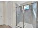 Walk-in shower with gray tile and glass door at 7706 Graben St, Kissimmee, FL 34747