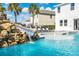 Water slide feature on a rock formation leading into the pool at 7706 Graben St, Kissimmee, FL 34747