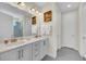 Bathroom with double vanity and gray tile at 7706 Graben St, Kissimmee, FL 34747