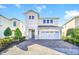 Two-story home with stone accents and a two-car garage at 7706 Graben St, Kissimmee, FL 34747