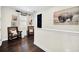 Upstairs hallway with dark hardwood floors and seating area at 7706 Graben St, Kissimmee, FL 34747