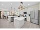 Open concept kitchen with island, stainless steel appliances, and white cabinets at 7706 Graben St, Kissimmee, FL 34747